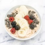 Smoothie bowl with bananas, berries and chocolate pieces